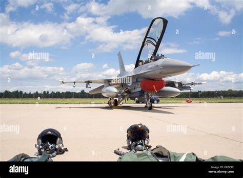 Norwegian Air Force F 16 Fighter Jet With Pilot Suits And Helmets In