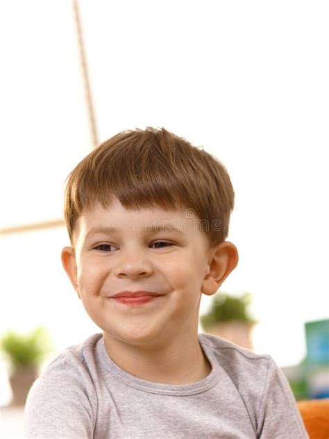 Five Year Old Blonde Girl In Park Smiles To Camera Vertical Stock