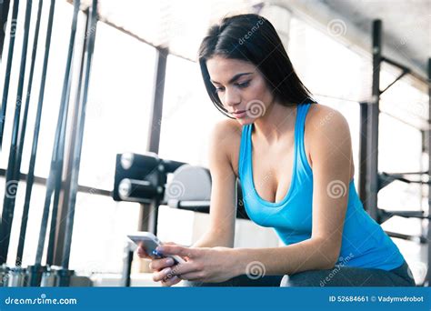 Woman Using Smartphone At Gym Stock Image Image Of Activity Pose 52684661