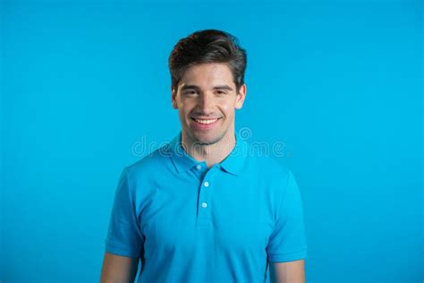 Portrait Of Smiling Cheerful Handsome Man In Blue T Shirt Looking To