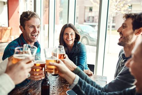 Its Time To Celebrate A Group Of Friends Making A Toast While Enjoying Themselves In A Bar