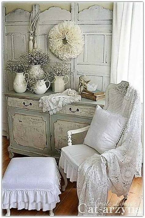 A Chair And Ottoman In A Room With White Decor On Top Of The Dressers