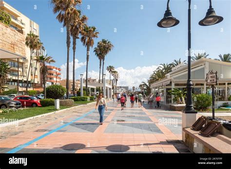 Carihuela Torremolinos Spain Tourists Walking Along The Waterfront