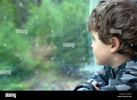 Orebro Boy Looking Through Window Stock Photo Alamy