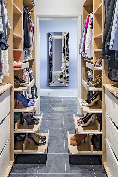 A Walk In Closet Filled With Lots Of Drawers And Shoes On Top Of Wooden