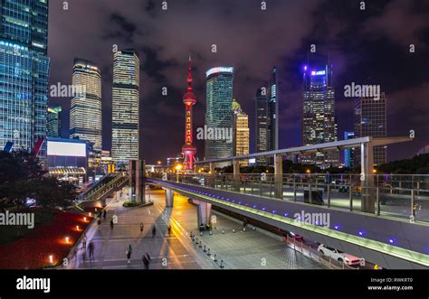 Pudong Skyline With Oriental Pearl Tower And Elevated Walkway At Night