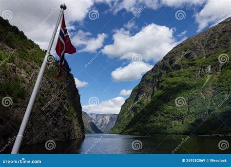 Norwegian Flag Against a Landscape in Narrow Fjord in Aurland in Vestland County, Norway Stock ...