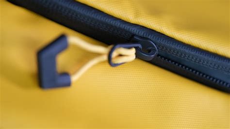 Premium Photo | Closeup of zipper with lock on yellow backpack bag