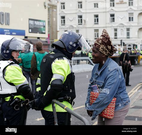 Black African Woman Confronting British Riot Police At Labour Party