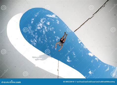 Extreme Man Jumping Over The Gap Between Concrete Walls Royalty Free