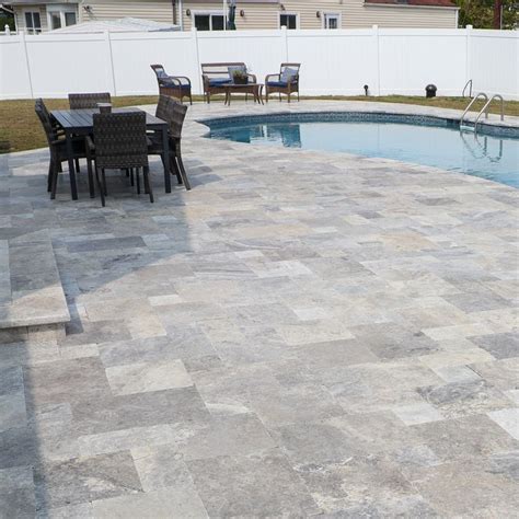 Freeform Pool Wrapped In Silver Travertine Copings And Pavers