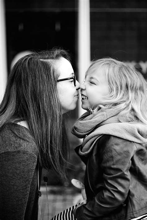 Black And White Photograph Of Two Women Kissing Each Other