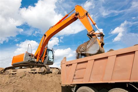 Backhoe Loading Soil Into Dump Truck Body Stock Photo Image Of Dumper