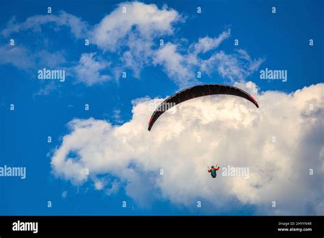 Flying Paraglider On A Background Of Blue Sky With Clouds Stock Photo