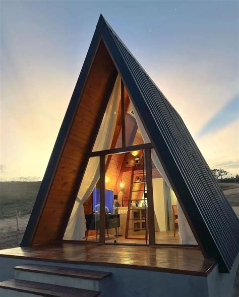 The Inside Of A House That Is Made Out Of Wood And Has A Pitched Roof