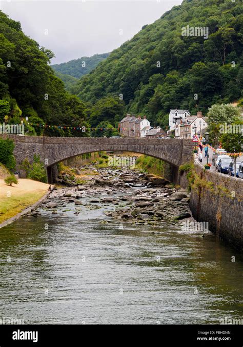 A Road Bridge Arches Over The Boulder Strewn East Lyn River At