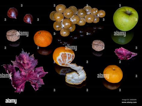 Beautiful Composition Of Autumnal Fruit And Leaves On A Shiny Black