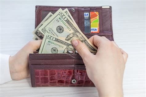 Premium Photo Cropped Hands Of Woman Holding Paper Currency In Purse