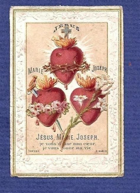 An Old Valentine S Day Card With Three Hearts And Flowers