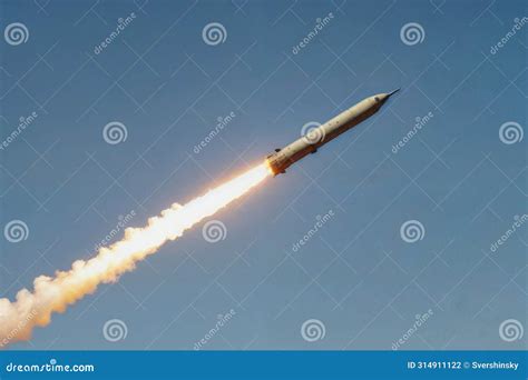 A Large Military Ballistic Rocket Is Flying Through The Blue Sky Stock