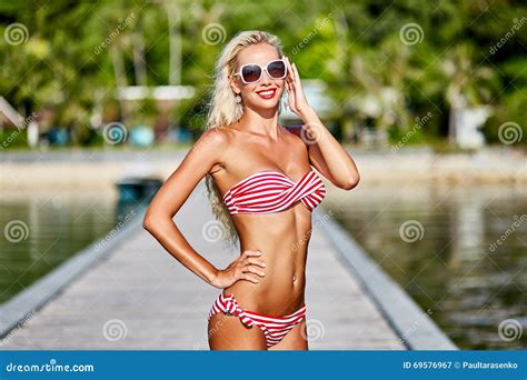 Pretty Tanned Blonde Woman In Bikini Posing Outdoor In Summertime Stock