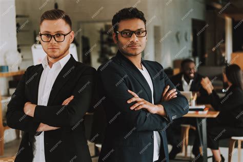 Premium Photo Two Serious Businessmen With Crossed Arms