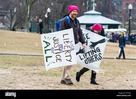 Man And Woman Wearing Pink Pussy Hats Joining The Boston Womens March