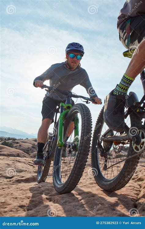 Doing What Outdoor Lovers Do Best Two Athletic Men Mountain Biking