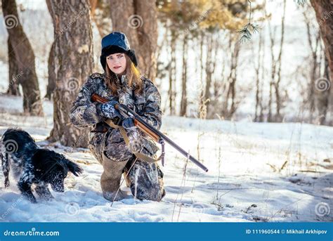 Female Hunter In Camouflage Clothes Ready To Hunt Holding Gun A Stock