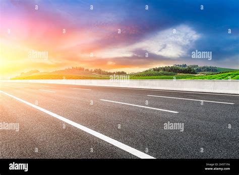 Asphalt Road And Mountain With Tea Plantation At Sunset Road And