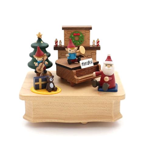 A Wooden Music Box With Figurines On It And A Santa Clause Playing The