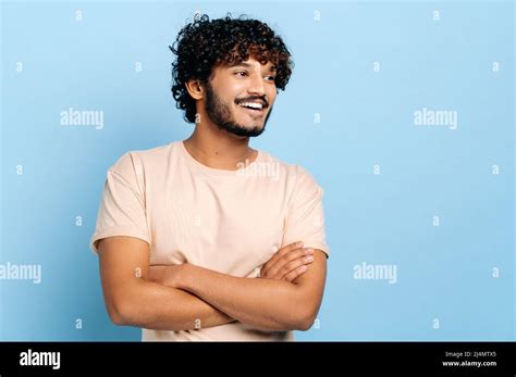 Handsome Positive Arabian Or Indian Curly Haired Millennial Guy In A T