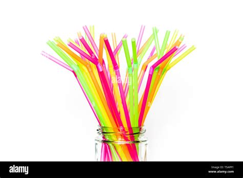 A Bunch Of Multicoloured Single Use Plastic Drinking Straws In Glass