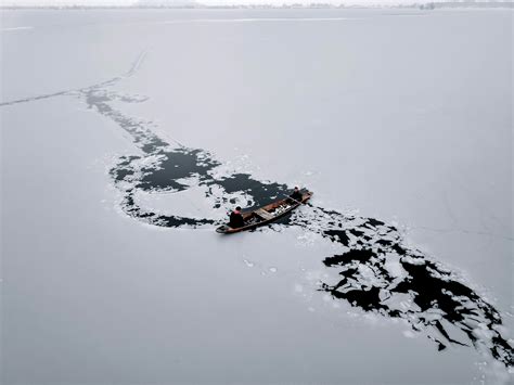 Men Fishing in a Frozen Lake · Free Stock Photo