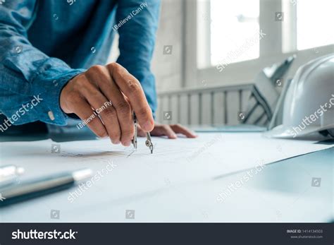 Engineers Pointing Building On Blueprint Using Stock Photo 1414134503