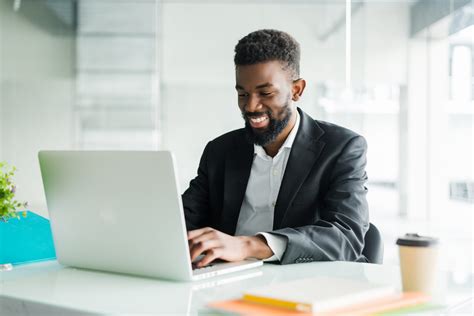 Thoughtful African American Businessman Using Laptop Pondering Project