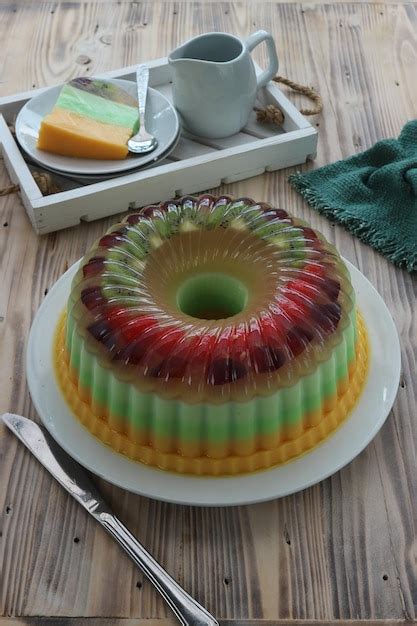 Premium Photo A Slice Of Jello Cake On A Plate With A Spoon Next To It