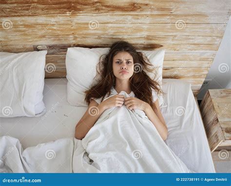 Upset Woman Lies In Bed Under The Covers Sadness Top View Stock Image