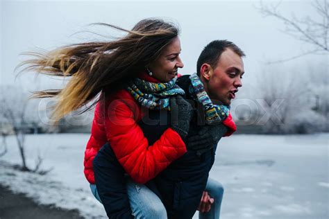 Man Carries His Girlfriend On Back Stock Image Colourbox