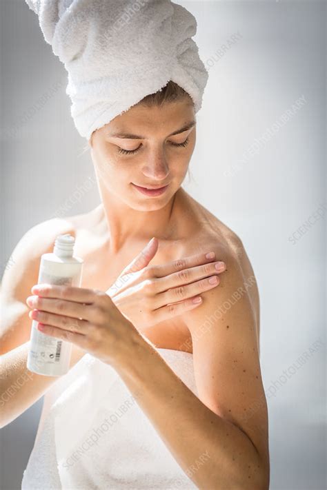 Woman Applying Cream On Her Arm Stock Image C034 7940 Science