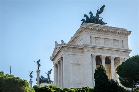 The Historic Building Of White Marble With Columns And Statues Of Horse