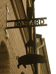 A Street Sign Hanging Off The Side Of A Building