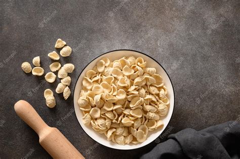 Premium Photo Fresh Raw Apulian Pasta Orecchiette Made From Whole Wheat Flour On A Dark Table