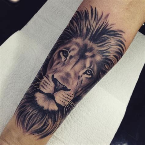 A Man S Arm With A Lion Tattoo On It