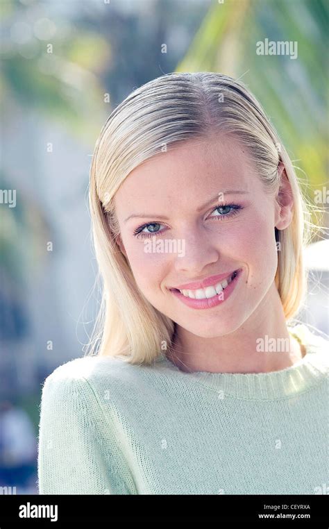 Female Long Straight Blonde Hair Wearing Pale Green Round Neck Jumper