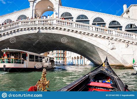 Traditional Gondola Near World Famous Canal Grande And Rialto Bridge