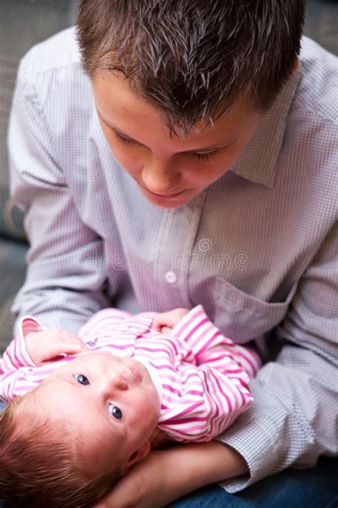 Teenage Guy Holding Baby