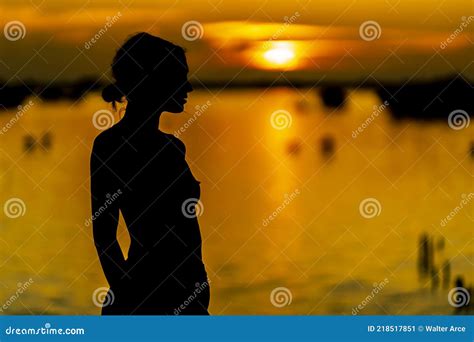A Lovely Nude Latin Model Is Silhouetted As She Poses With The Rising