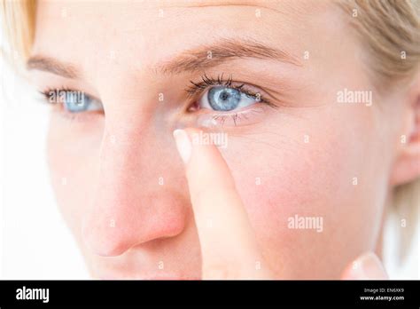 Pretty Blonde Applying Contact Lens Stock Photo Alamy