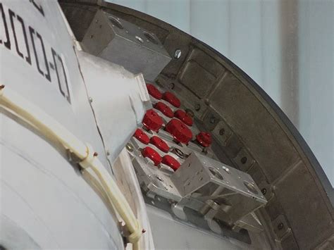 the back end of an airplane with red seats